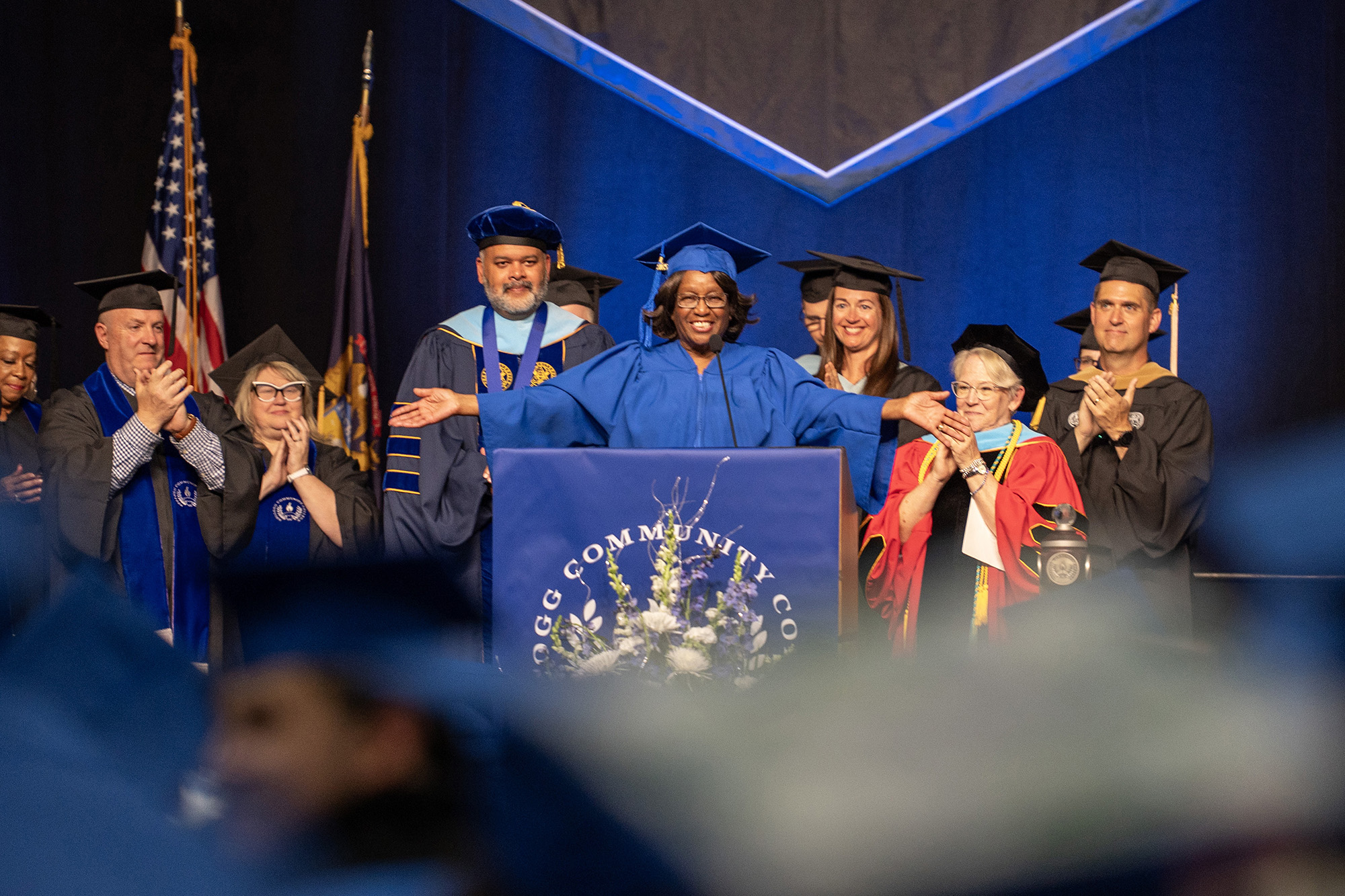 Maude Bristol-Perry gestures to the crowd of graduates after delivering her Commencement speech at Commencement.