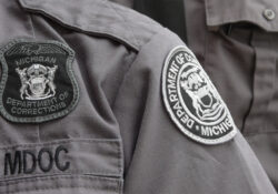 Close up photo of badges and patches on corrections officer uniforms.