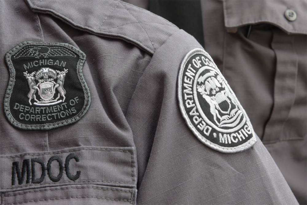 Close up photo of badges and patches on corrections officer uniforms.