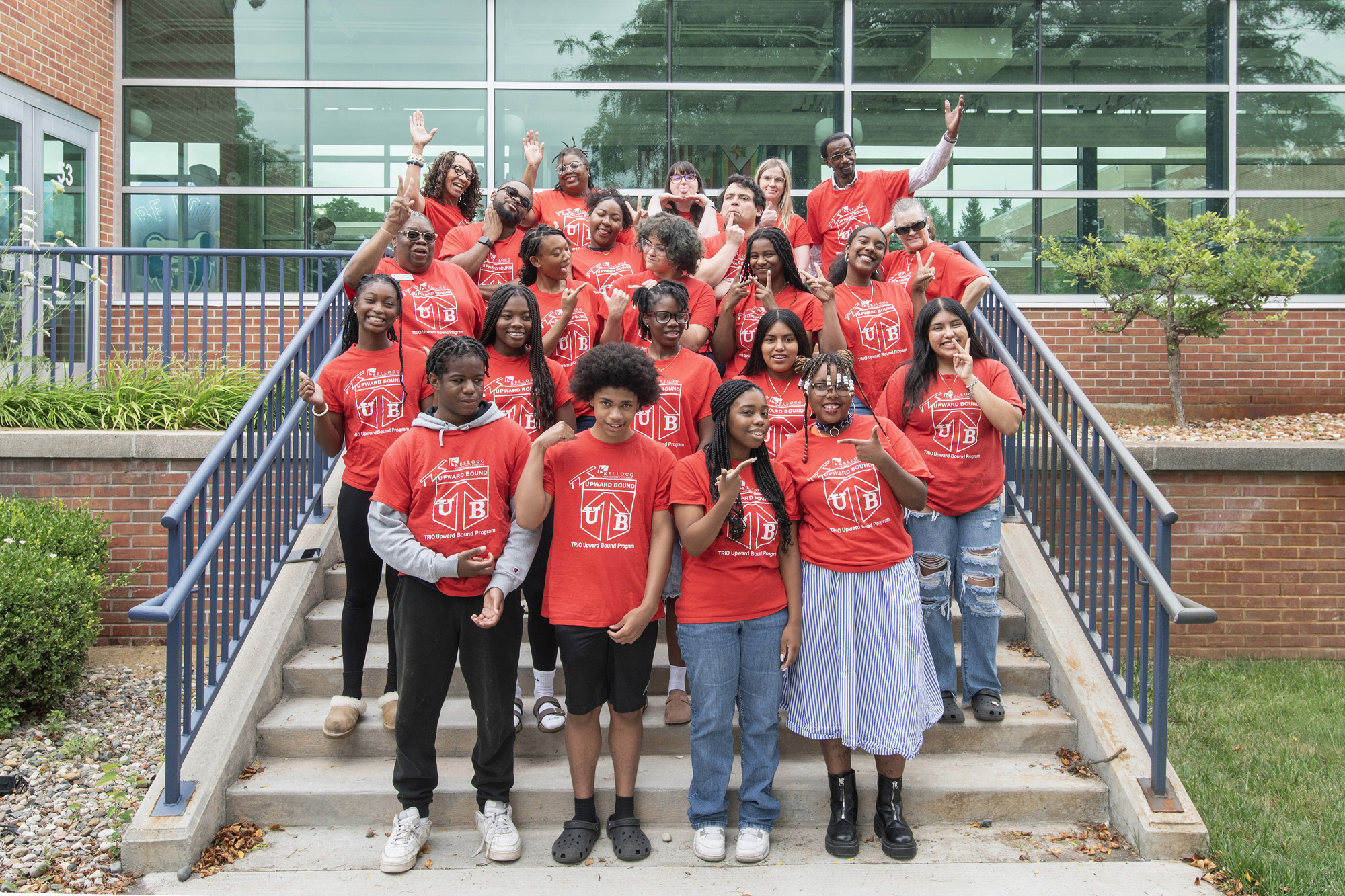 A group photo of Upward Bound students on a set of stairs outside on campus.