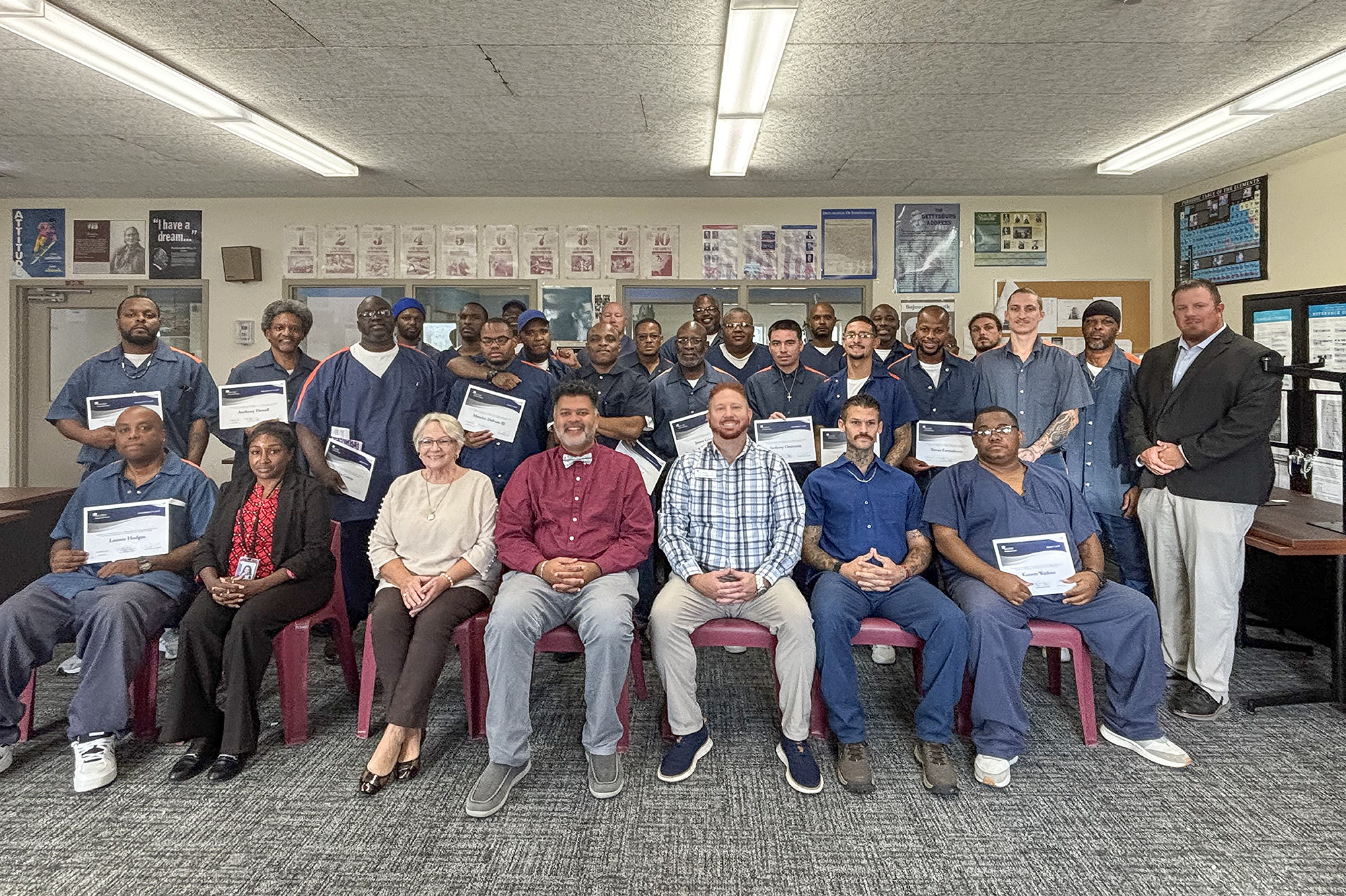 KCC officials pose for a group photo with Prison Education Program students at Lakeland Correctional Facility.
