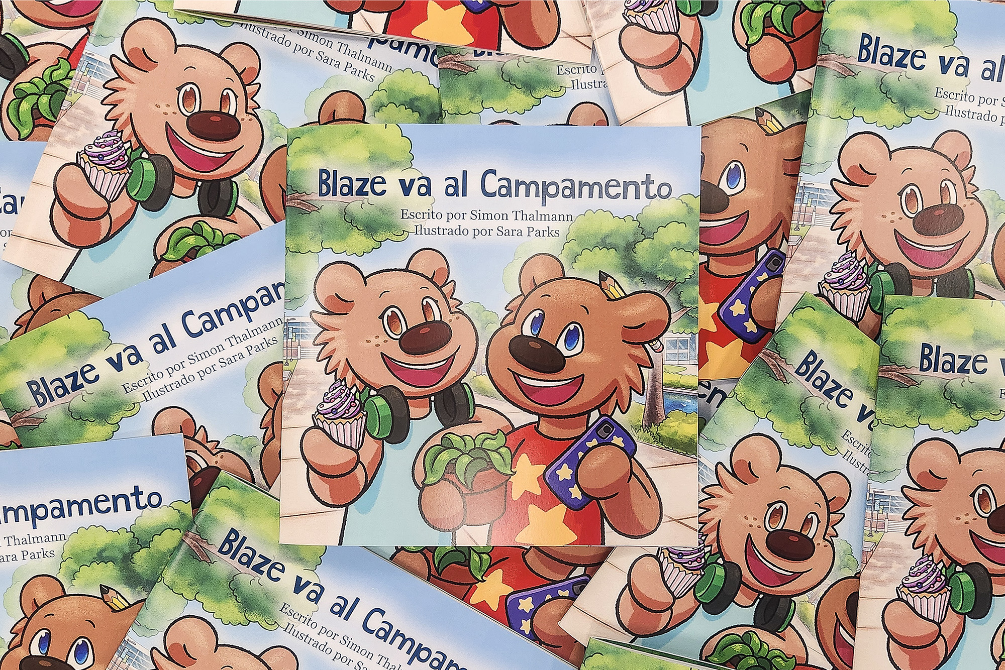 A pile of copies of the children's book "Blaze va al Campamento," featuring illustrations of two cartoon bears on the covers.