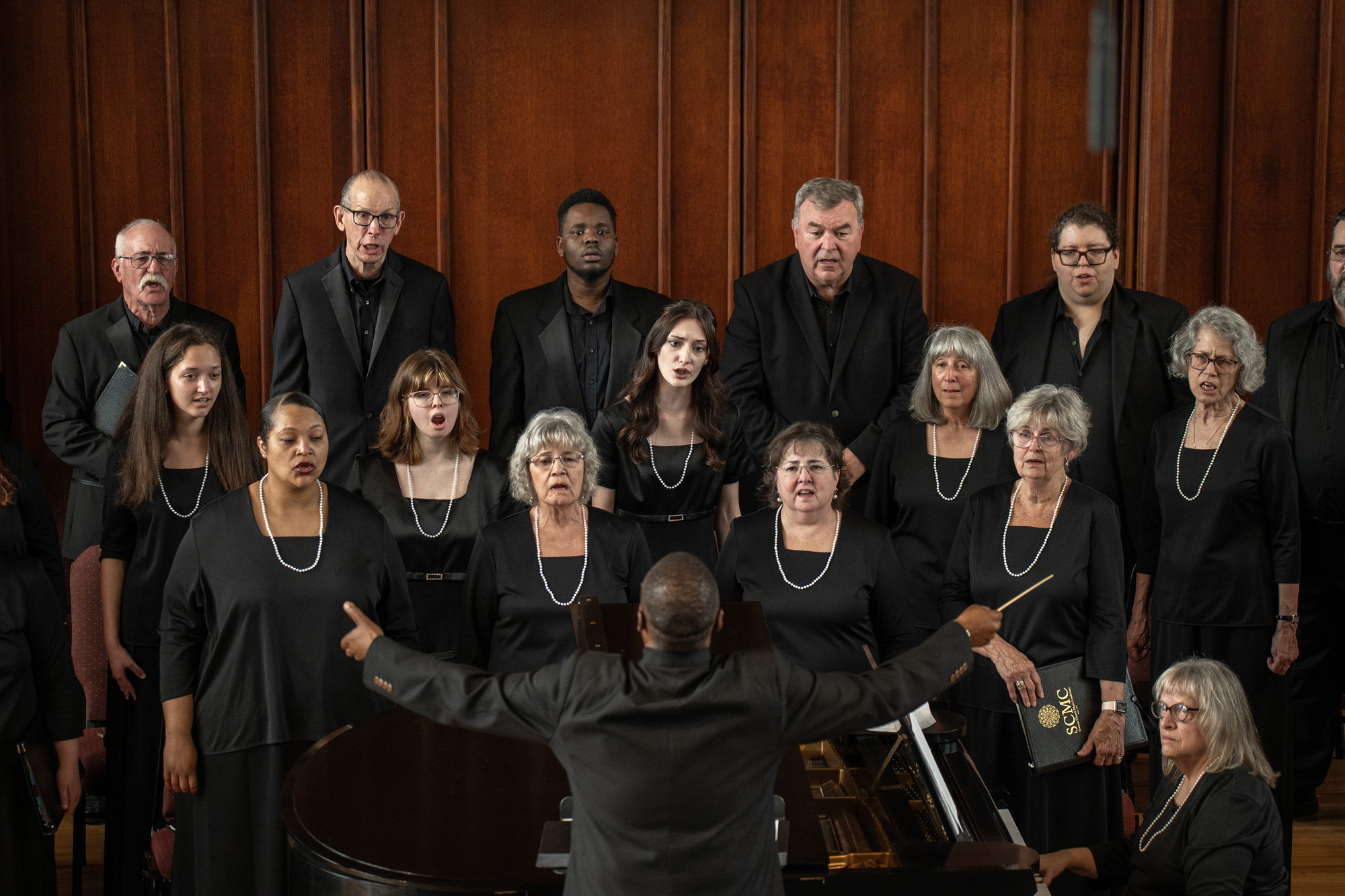 Choir members sing during a concert.