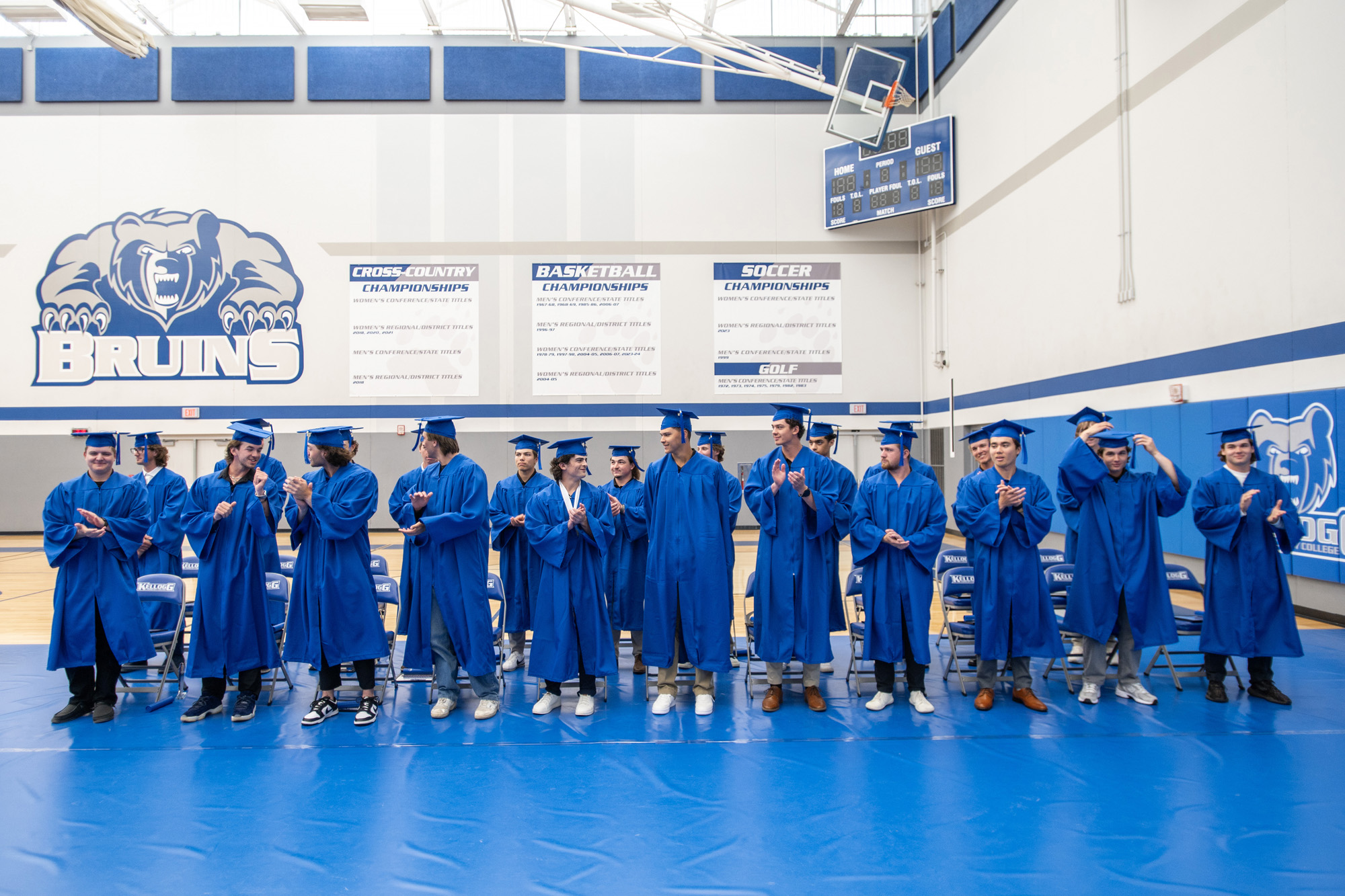 KCC baseball graduates in commencement caps and gowns celebrate following a special commencement ceremony held for baseball graduates in the College’s Miller Gym in May.
